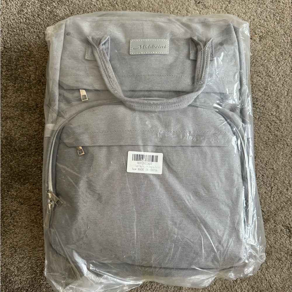 New in packaging! Diaper bag with changing station and straps!